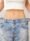 Woman showing weight loss results by wearing loose jeans at a weight loss clinic in Indiranagar